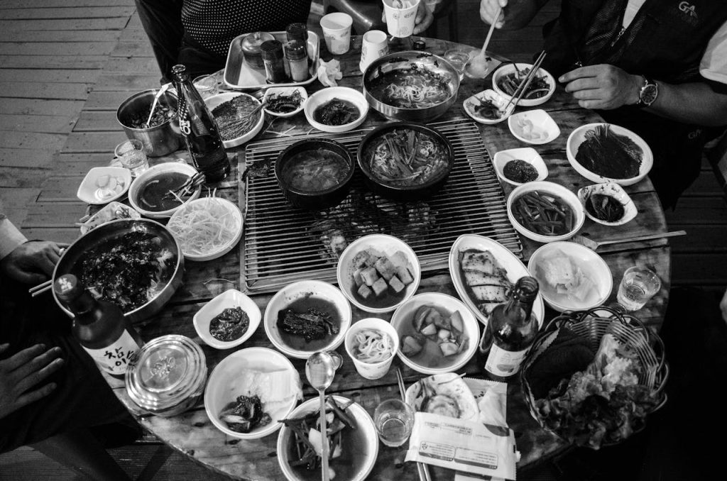 Visiting Priory Park Cafe: Hours, Parking and Bookings A monochrome image of a diverse Korean dinner spread viewed from above, featuring various dishes and ingredients.